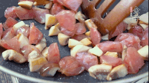 【餡料】4.鍋中油8成熱時(shí)，依次放入菌菇丁、香腸丁，適當(dāng)放點(diǎn)糖調(diào)味，炒熟。
