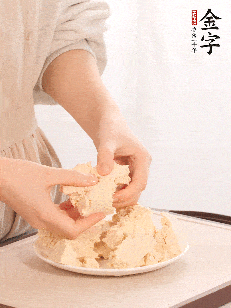 老豆腐用手掰成塊。